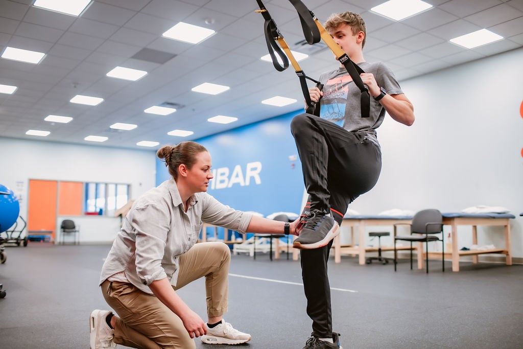 Dr. Molly Douglass works with a high school athlete